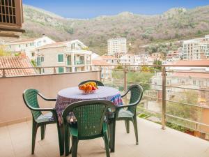 a table with a bowl of fruit on a balcony at Bel&Rus Sea Apartment in Budva