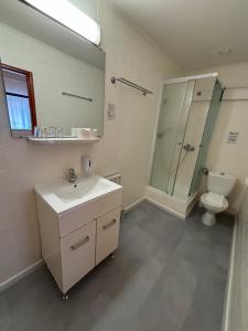 a bathroom with a sink and a toilet and a mirror at Hotel Gloria Budapest City Center in Budapest +37 photos