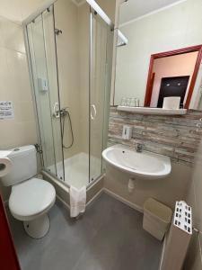 a bathroom with a toilet and a sink and a shower at Hotel Gloria Budapest City Center in Budapest