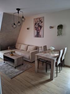 a living room with a table and a couch at S S Apartman in Divčibare +11 photos