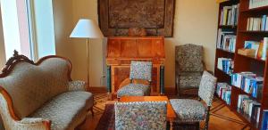 a living room with two chairs and a table at Eifeler Hof - Ihr Restaurant für Genussmomente in Kyllburg in Kyllburg