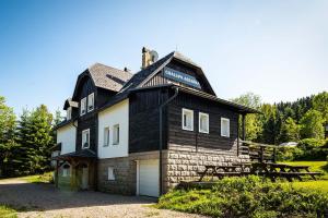 a black and white house with a gambrel roof at Chata Adlerka in Bedřichov