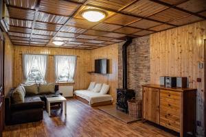 a living room with a couch and a fireplace at Chata Adlerka in Bedřichov