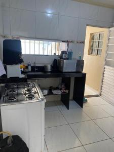 a kitchen with a stove and a counter top at Casa grande in Garanhuns