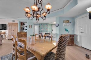 ein Esszimmer und ein Wohnzimmer mit Tisch und Stühlen in der Unterkunft 3105 Windsor Court South Oceanfront Luxury 2 BR condo Pool Bike Paths Golf Courses in Hilton Head Island