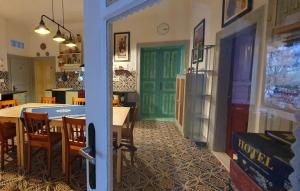 a dining room with a table and a green door at Csacsiország Vendégház in Nógrádsáp