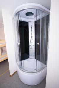 a shower with a glass enclosure with a shower at Hostel Metro in Warsaw