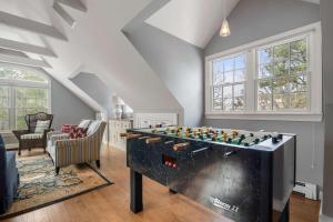 a living room with a large game table at Luxury Waterfront with Game Room in Chatham