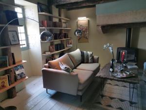 a living room with a couch and a table at La Maison Médiévale à colombage en Quercy in Puylagarde