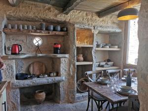a dining room with a table and a fireplace at La Maison Médiévale à colombage en Quercy in Puylagarde