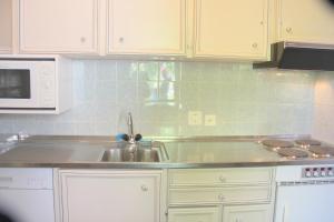 a kitchen with a sink and a microwave at Barony Le Pergole Lugano - 2 persons in Lugano