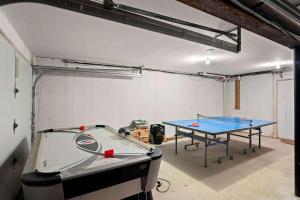 a ping pong table in a room with a ping pong ball at Pool Half Mile to Beach in Harwich