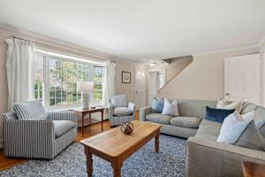 a living room with a couch and chairs and a table at Pool Half Mile to Beach in Harwich