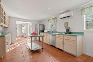 a kitchen with green counter tops and a table at Pool Half Mile to Beach in Harwich