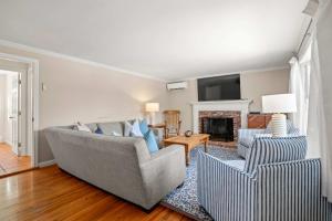 a living room with two couches and a fireplace at Pool Half Mile to Beach in Harwich +28 photos