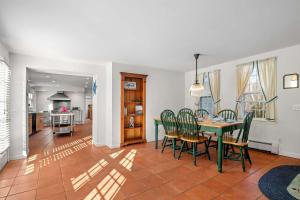 a dining room and kitchen with a table and chairs at Pool Half Mile to Beach in Harwich