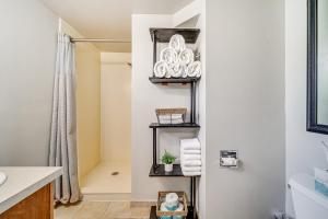 a bathroom with white walls and a sink and shelves at 1 Mi to Camels Back Park Boise Studio with Patio! in Boise +18 photos