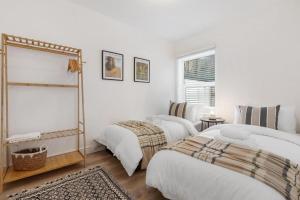 a bedroom with two beds and a window at Furnished Terraced House near Public Attractions, 5 min to Public Transport in Hemel Hempstead