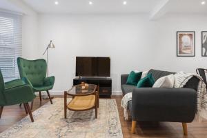 a living room with a couch and two chairs at Furnished Terraced House near Public Attractions, 5 min to Public Transport in Hemel Hempstead