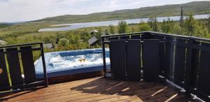 a hot tub on the deck of a house at Torsetlia Cottages and Apartments in Uvdal