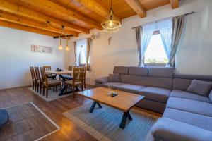 a living room with a couch and a table at Vikend Kuća Mirko in Risovac