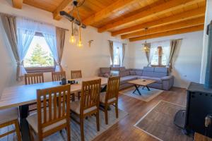 a living room with a table and chairs and a couch at Vikend Kuća Mirko in Risovac +9 photos