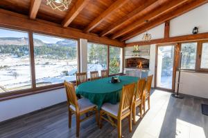 a dining room with a table and chairs and a fireplace at Vikend Kuća Mirko in Risovac