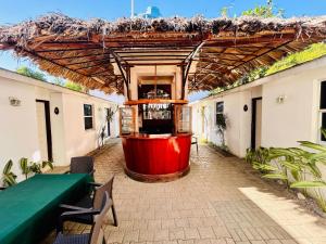 a building with a large wine barrel under a roof at Arawak Hotel in Léogâne