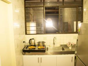 a kitchen counter with a sink and a stove at Hotel Casa Manta Cali in Cali