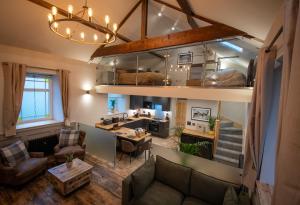 a living room with a couch and a loft at The Old Chapel, Peak District in Bamford