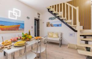 a dining room with a table and a staircase at Nel Borgo Antico in Riomaggiore