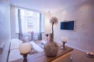 a living room with a vase on a table at Design Suites Palma in Palma de Mallorca