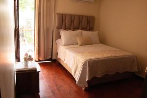 Postel nebo postele na pokoji v ubytování Hotel Casa Manta Cali