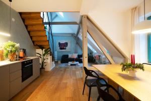 a kitchen with a table and chairs in a room at Design Studio in Hinterhof-Remise in Leipzig