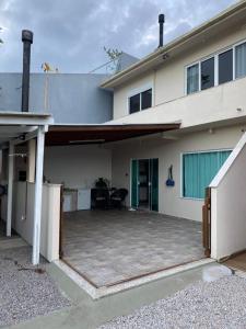 a house with a large patio in front of it at Casa em Governador Celso Ramos in Governador Celso Ramos