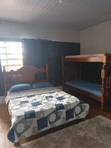 a bedroom with two bunk beds and a rug at casarao24horas in Cuiabá +2 photos