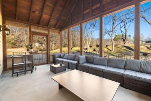 a living room with a couch and a table at Whispering Brook in Springdale