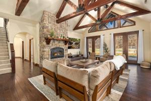 a living room with a couch and a fireplace at Whispering Brook in Springdale +34 photos