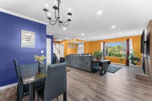 a living room with a couch and a table at Colorful and Cozy Haven with Heated Pool in Rodeo