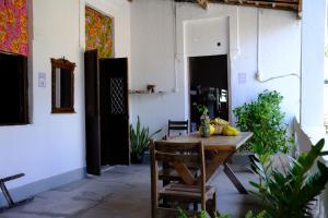 a wooden table with bananas on it in a room at Hostel Divino do Carmo in Olinda