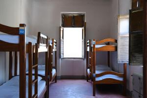 a room with several bunk beds and a window at Hostel Divino do Carmo in Olinda