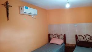 a room with a bed and a air conditioner at Departamento Eva in Deán Funes +9 photos