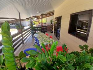 a patio with a table and chairs on a balcony at Ohotu-Rangiroa house in Rangiroa
