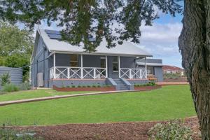 a house with a solarium on the front of it at Adelaide Hills Luxury Cottage - The Gladys in Carey Gully