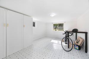 a bike parked in a room with white walls at Adelaide Hills Luxury Cottage - The Gladys in Carey Gully