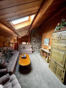 a living room with a couch and a table at Timberline Cabin Near Bozeman in Bozeman