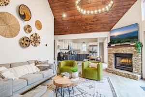a living room with a couch and a fireplace at Stunning Mtn Cabin,Mtn Views,Hot Tub,Pet friendly in Waynesville
