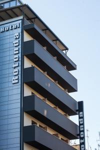 a building with a sign on the side of it at Rotonda Hotel in Thessaloniki