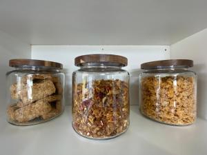 three glass jars filled with different types of granola at The Park Cottage in Napier