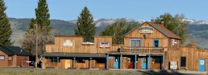 a large wooden building in front of a mountain at Blue Moon Saloon in Cameron